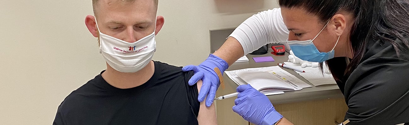 A healthcare worker giving a vaccine