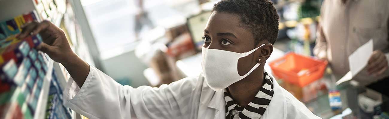 female pharmacist dispensing meds