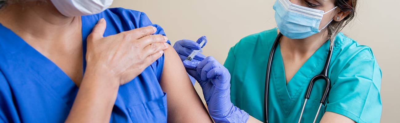 A healthcare worker giving a vaccine