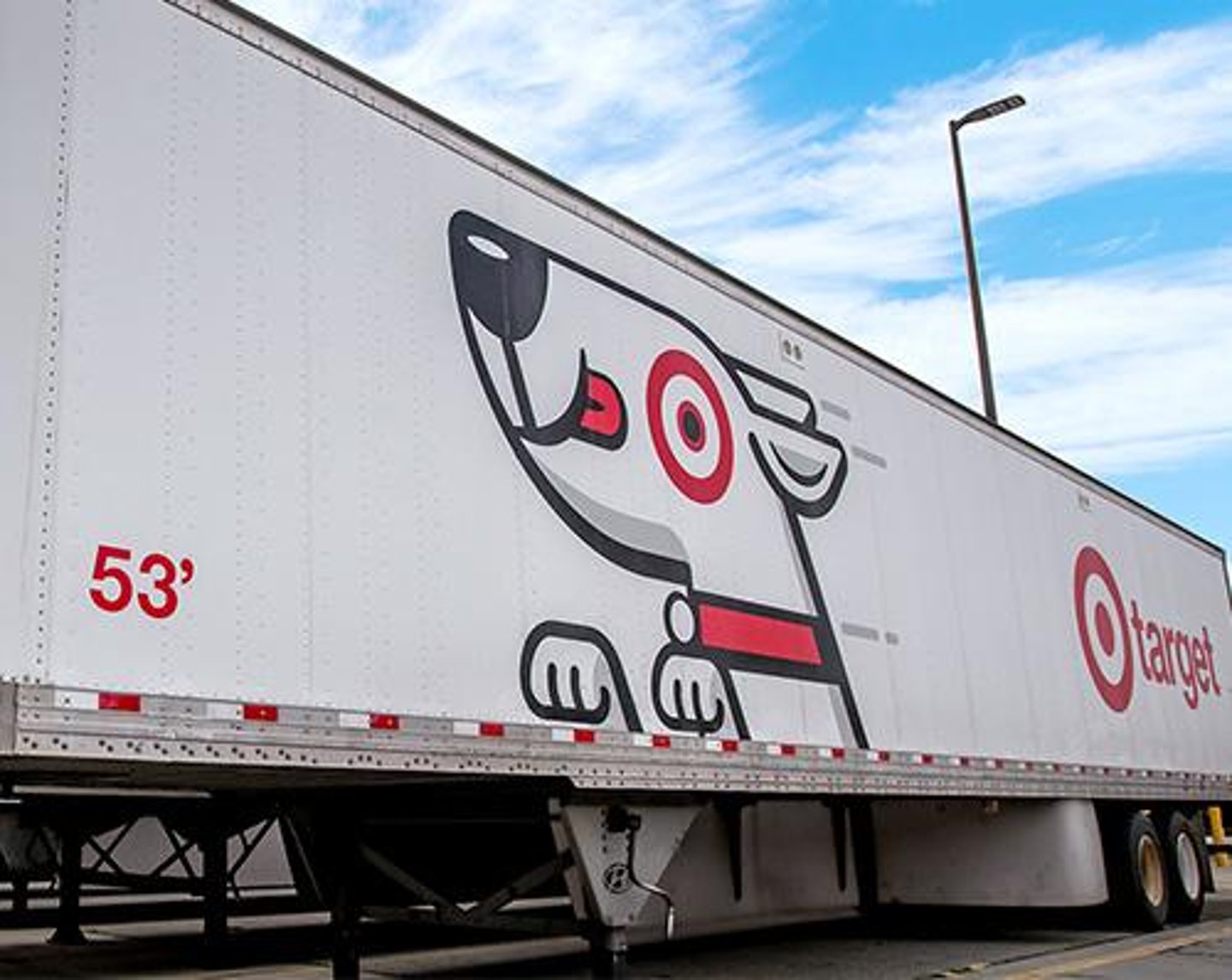 a truck that has a sign on the side of a bridge