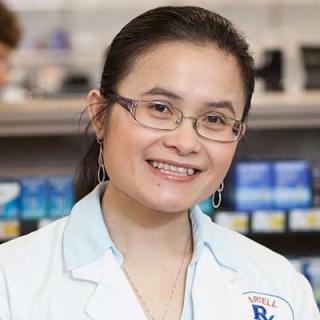a person wearing glasses and smiling at the camera