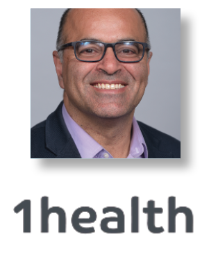 a man wearing glasses and smiling at the camera