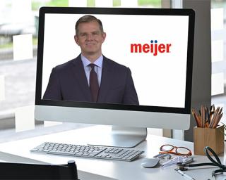 a man sitting at a desk in front of a computer screen