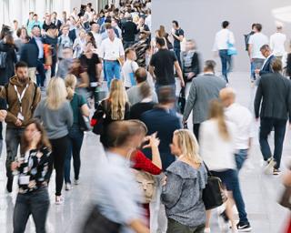 A group of people walking in front of a crowd