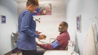 walgreens-clinician-with-patient