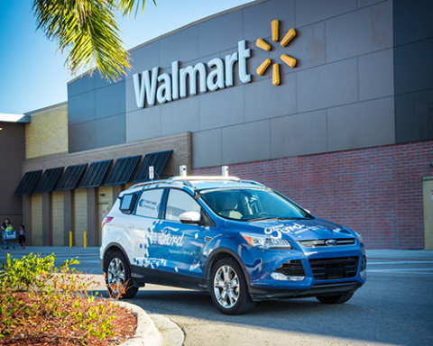 a blue car parked in front of a building