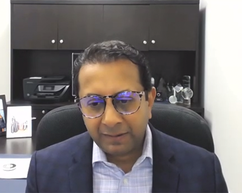 Nimesh Jhaveri wearing glasses and smiling at the camera