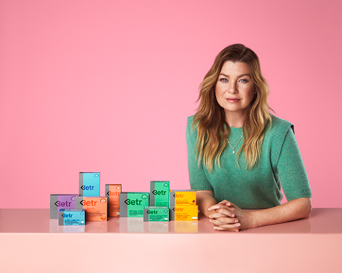 Ellen Pompeo sitting on a table