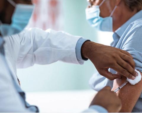 Pharmacist administering vaccine Pharmacist administering vaccine